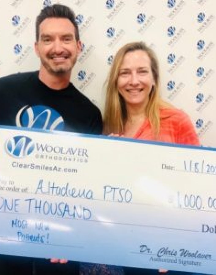 Dr. Woolaver and his wife carrying a check at a token of apppreciation