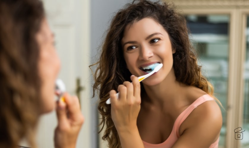 A girl brushing her teeth.